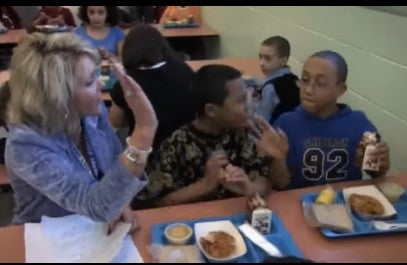 Kerry Purcell high-fives a student