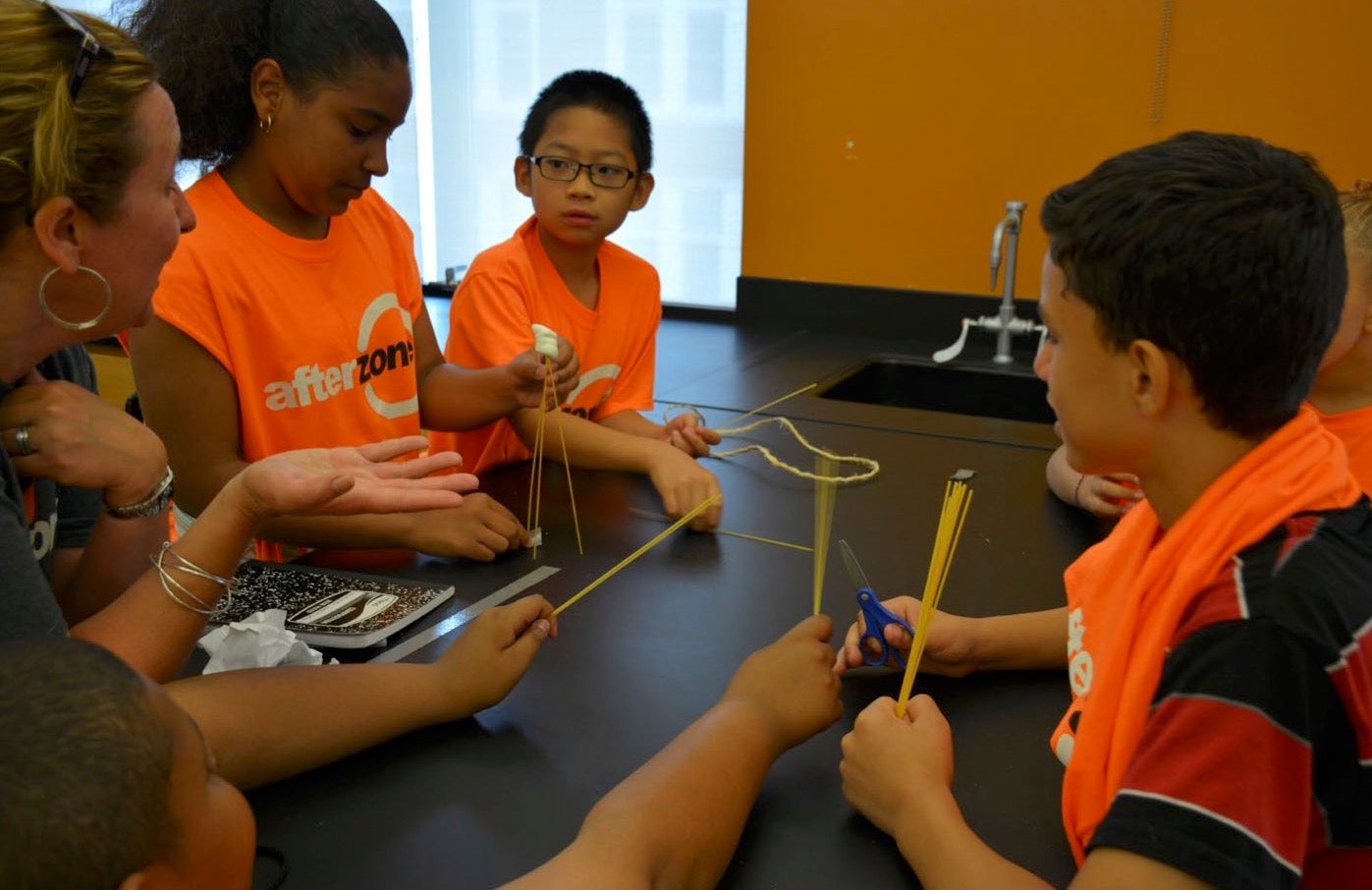 Children collaborate with each other on a project.