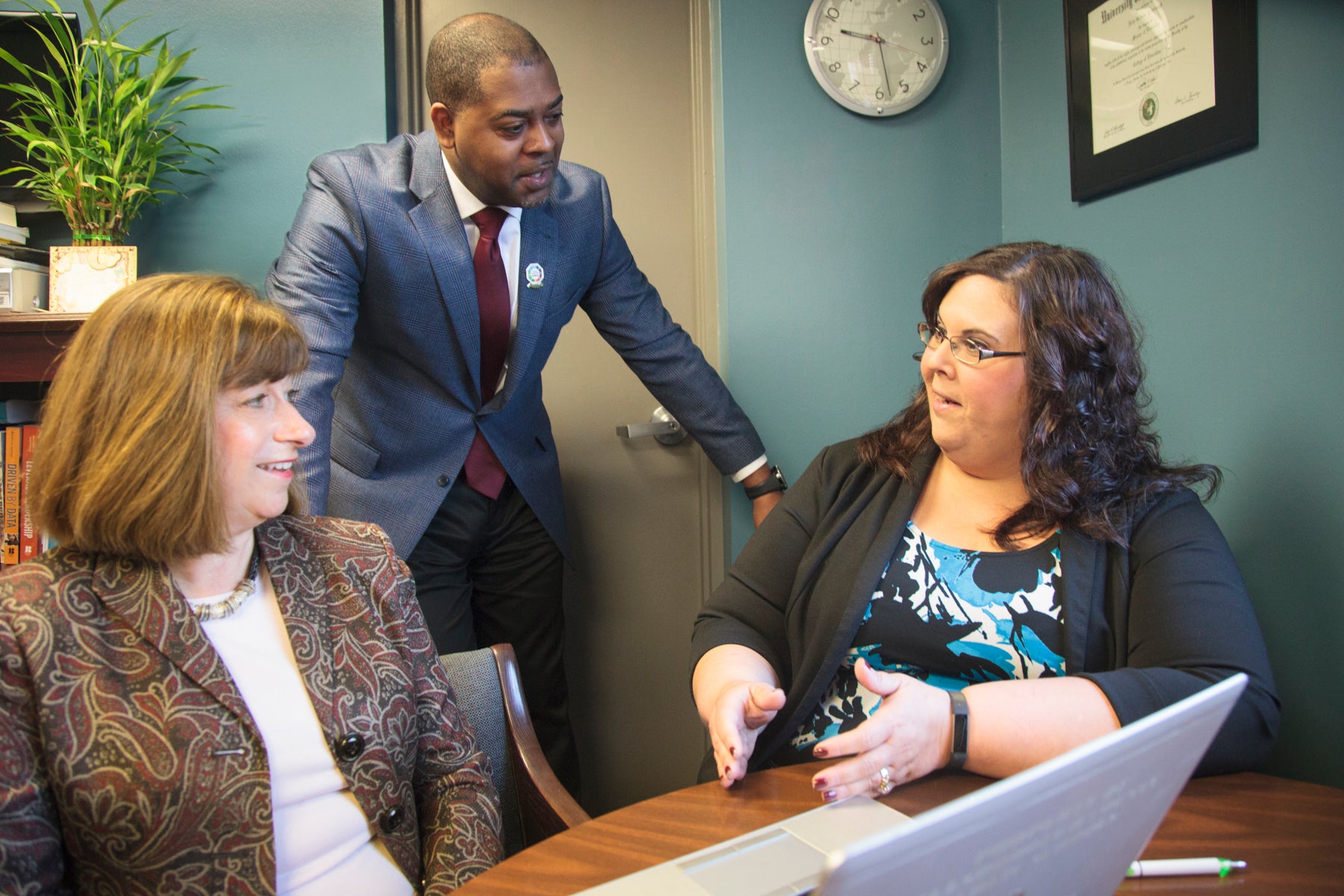Three education leaders in discussion.