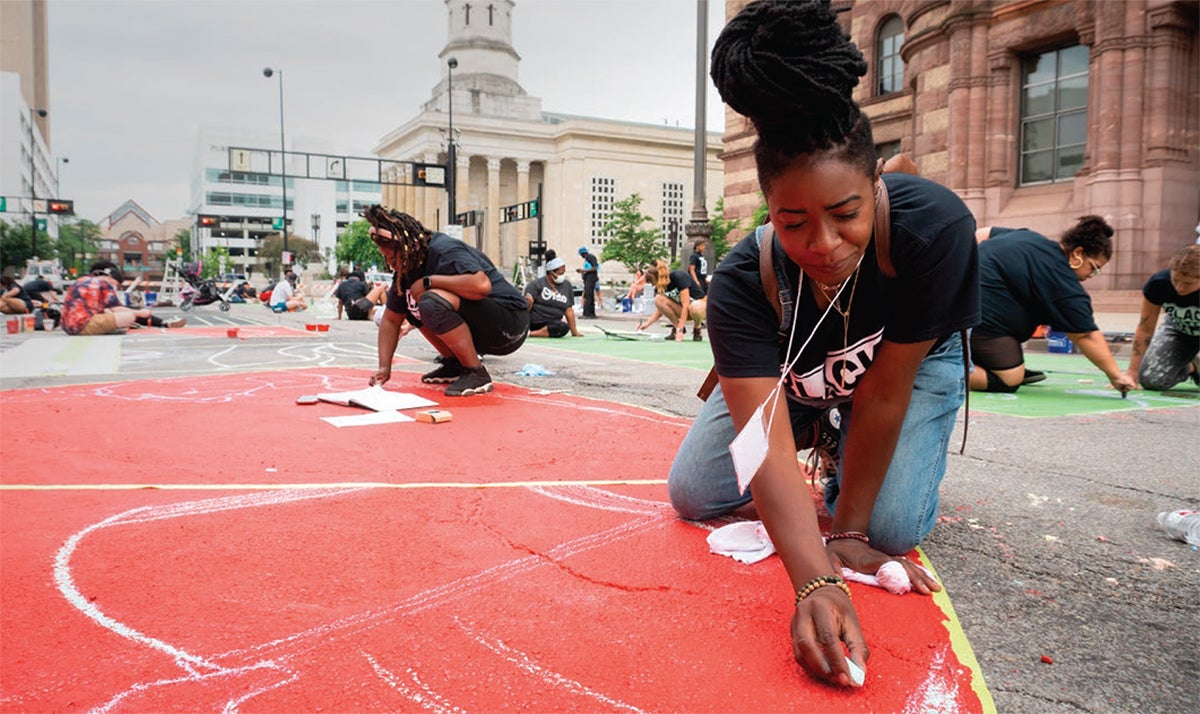 Arts kids drawing with chalk on sidewalk