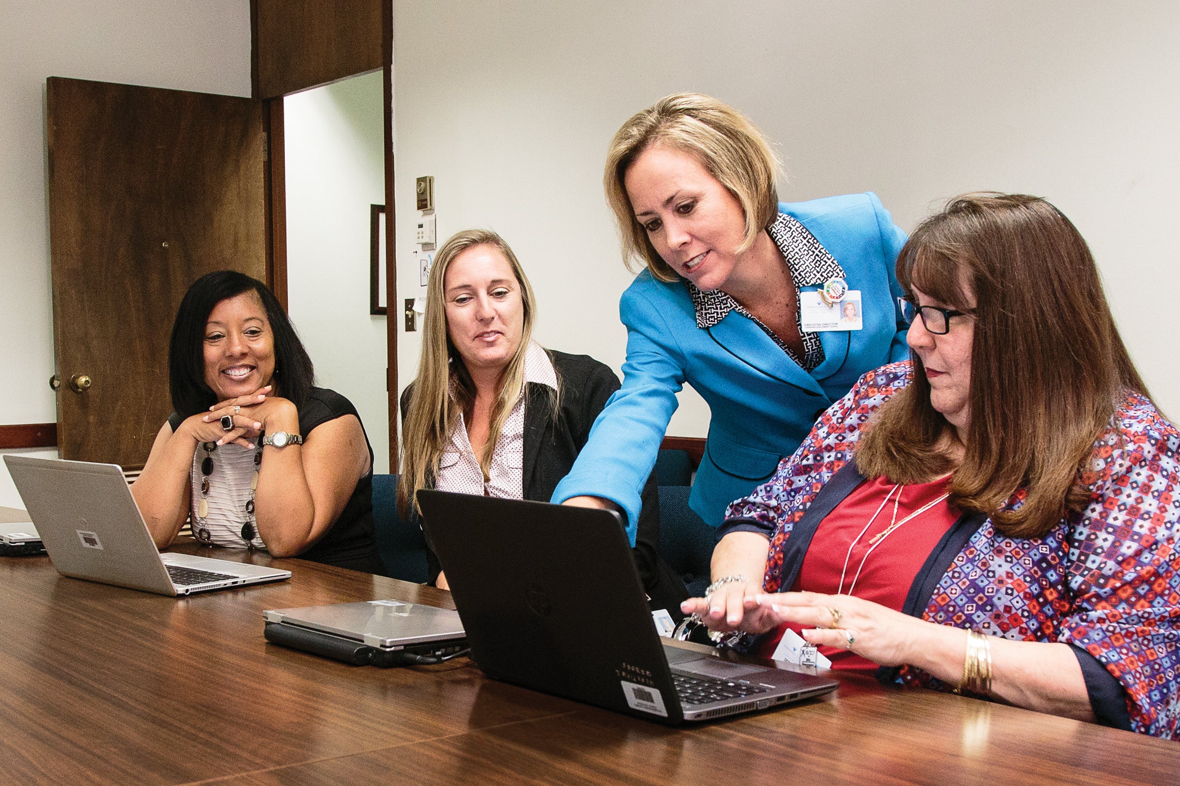 women in conference room, finance
